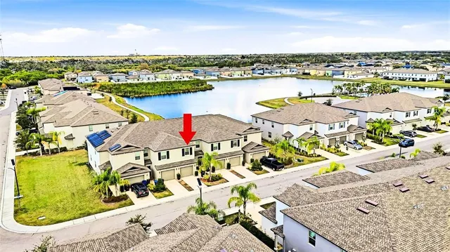 an aerial view of residential houses with outdoor space