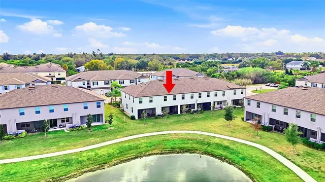 a aerial view of a house with swimming pool and a yard