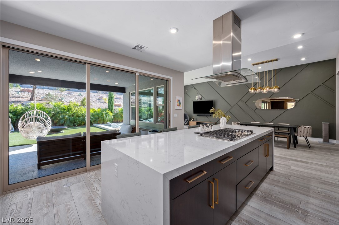 9719 Starlight Ridge Avenue Las Vegas, NV 89148 - Photo 8 of 25 A spacious, open-concept living space integrates a gourmet kitchen with serene outdoor views.