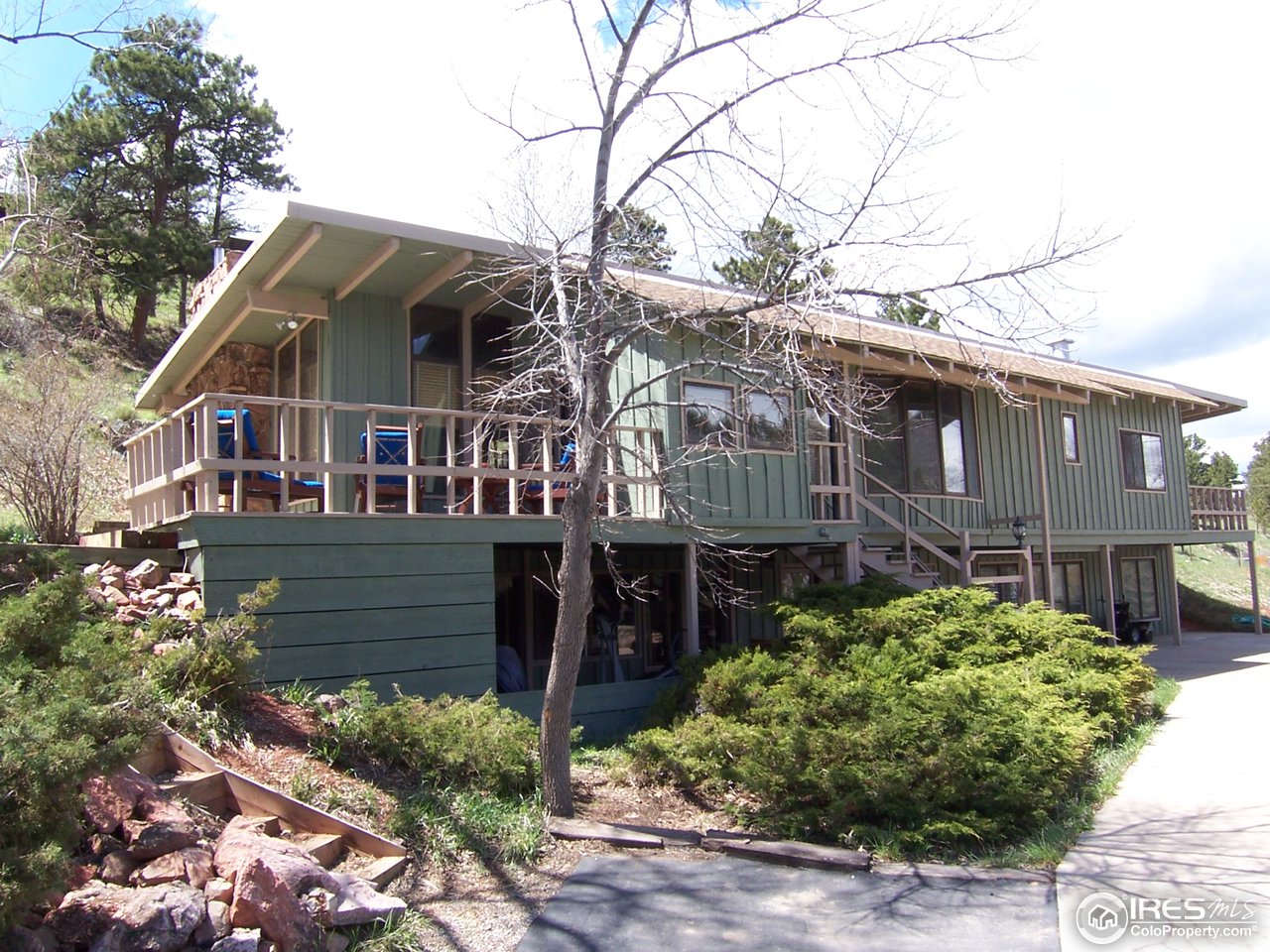 6419 Olde Stage Road Boulder, CO 80302 - Photo 1 of 21 a front view of a house with a garden