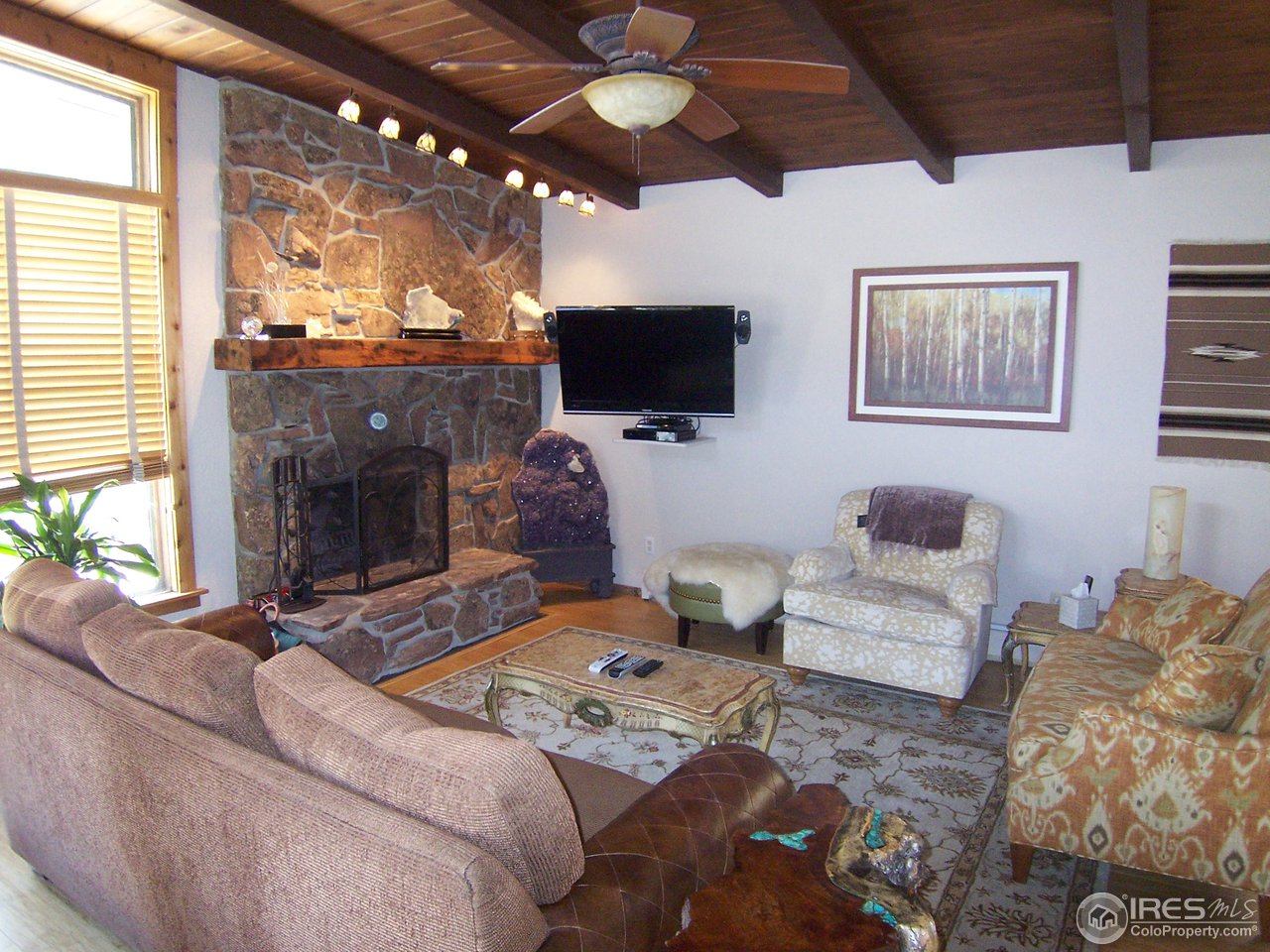 6419 Olde Stage Road Boulder, CO 80302 - Photo 3 of 21 a living room with furniture and a flat screen tv