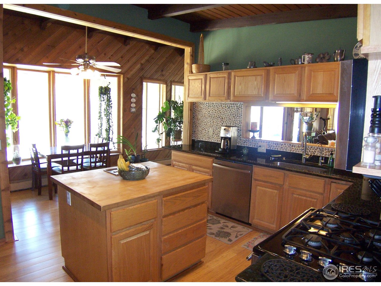 6419 Olde Stage Road Boulder, CO 80302 - Photo 6 of 21 a kitchen with sink a window and chairs