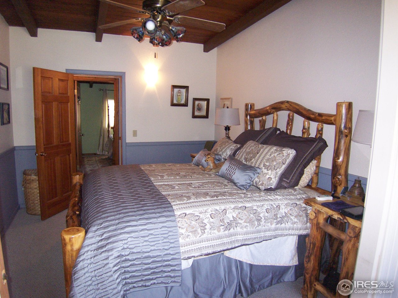 6419 Olde Stage Road Boulder, CO 80302 - Photo 9 of 21 a bedroom with a bed and a mirror