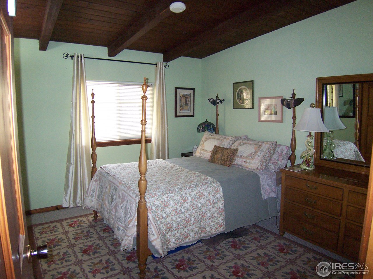6419 Olde Stage Road Boulder, CO 80302 - Photo 10 of 21 a bed room with a bed and a dresser