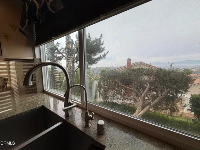 a kitchen with granite countertop a refrigerator stove top oven and sink