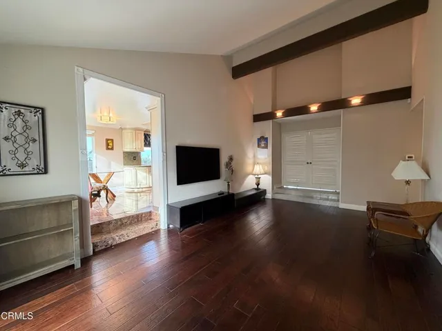a view of a livingroom with furniture and a window