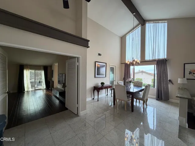 a view of a dining room with furniture and a window
