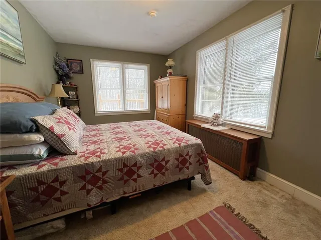 a bedroom with a bed next to a window