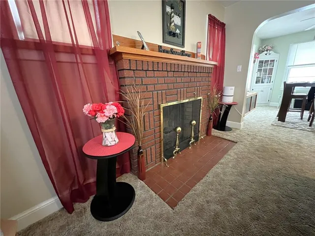 a view of a room with furniture and a fireplace