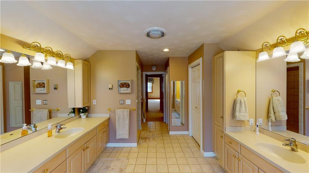8271 Prindle Road Erie, PA 16510 - Photo 17 of 25 a bathroom with a tub a sink and a large mirror