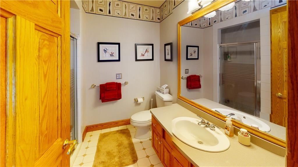 8271 Prindle Road Erie, PA 16510 - Photo 23 of 25 a bathroom with a sink mirror and toilet