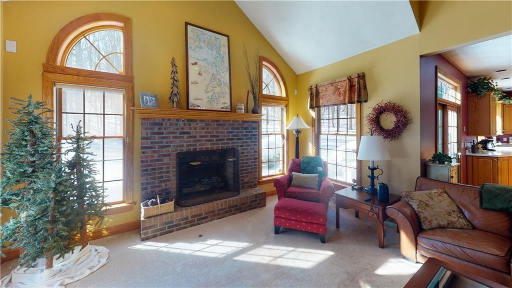 8271 Prindle Road Erie, PA 16510 - Photo 9 of 25 a living room with furniture a window and a fireplace
