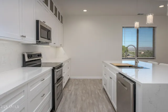 a kitchen with a sink stove and microwave