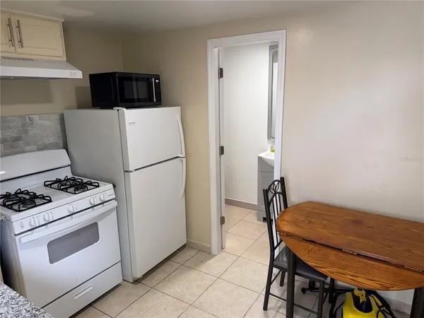 a kitchen with a stove and a refrigerator