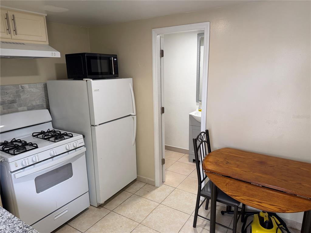 613 Carol Terrace, Unit 2 Kissimmee, FL 34744 - Photo 2 of 7 a kitchen with a stove and a refrigerator
