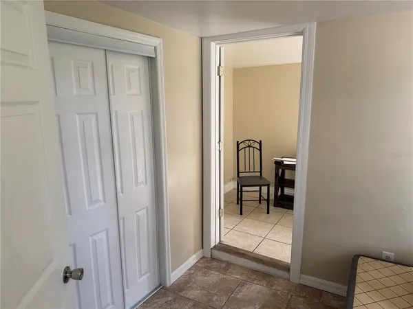 a view of a hallway and a dining room with a mirror