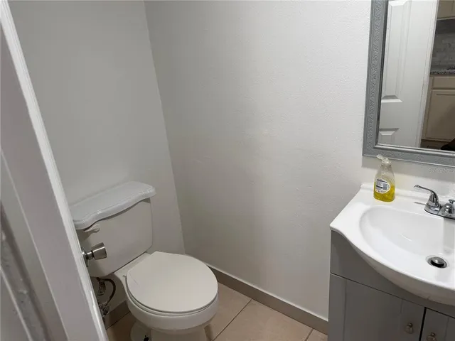 a white toilet sitting next to a bathroom sink