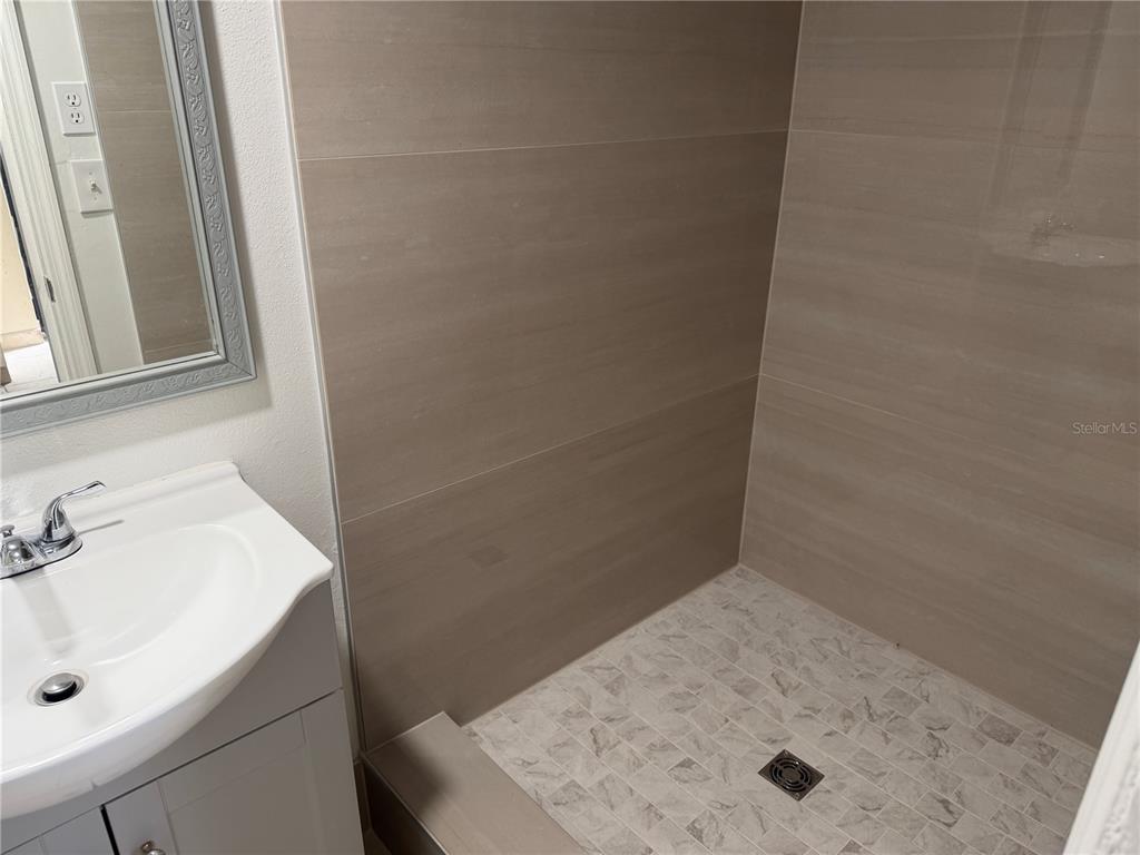 613 Carol Terrace, Unit 2 Kissimmee, FL 34744 - Photo 6 of 7 a bathroom with a sink and a vanity
