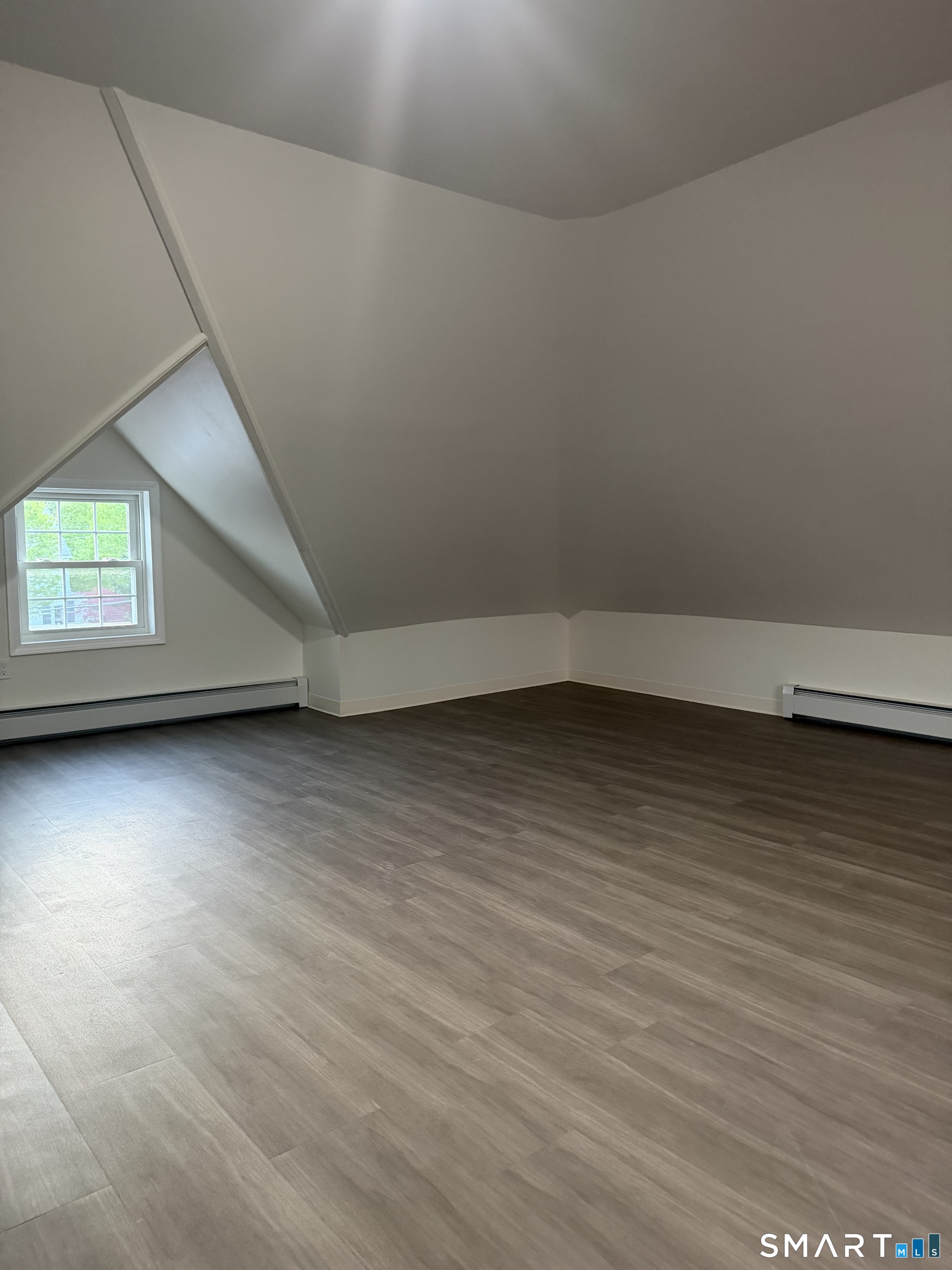 11 Strant Street Manchester, CT 06040 - Photo 4 of 8 an empty room with wooden floor and windows