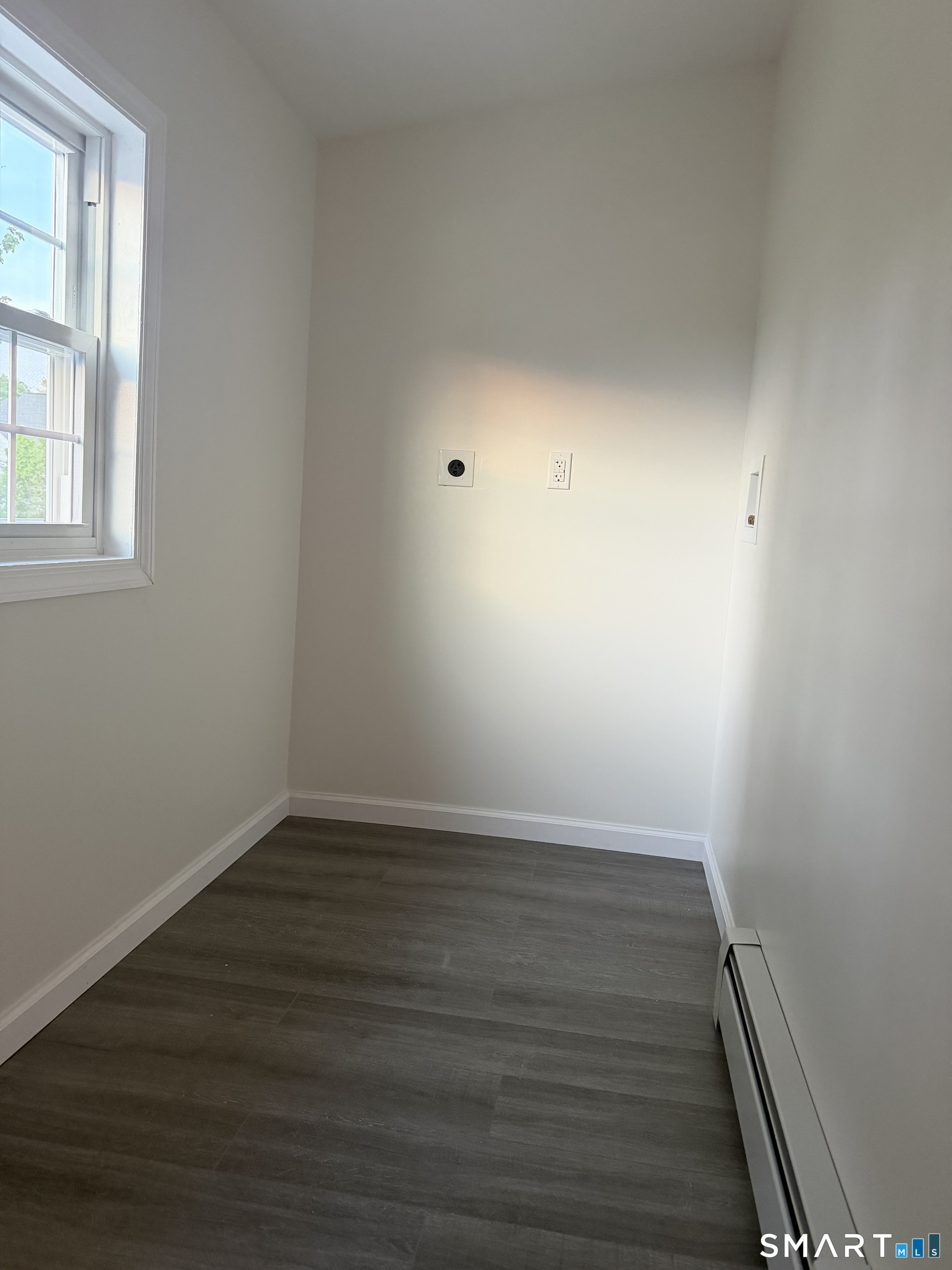 11 Strant Street Manchester, CT 06040 - Photo 6 of 8 a view of an empty room with wooden floor and a window
