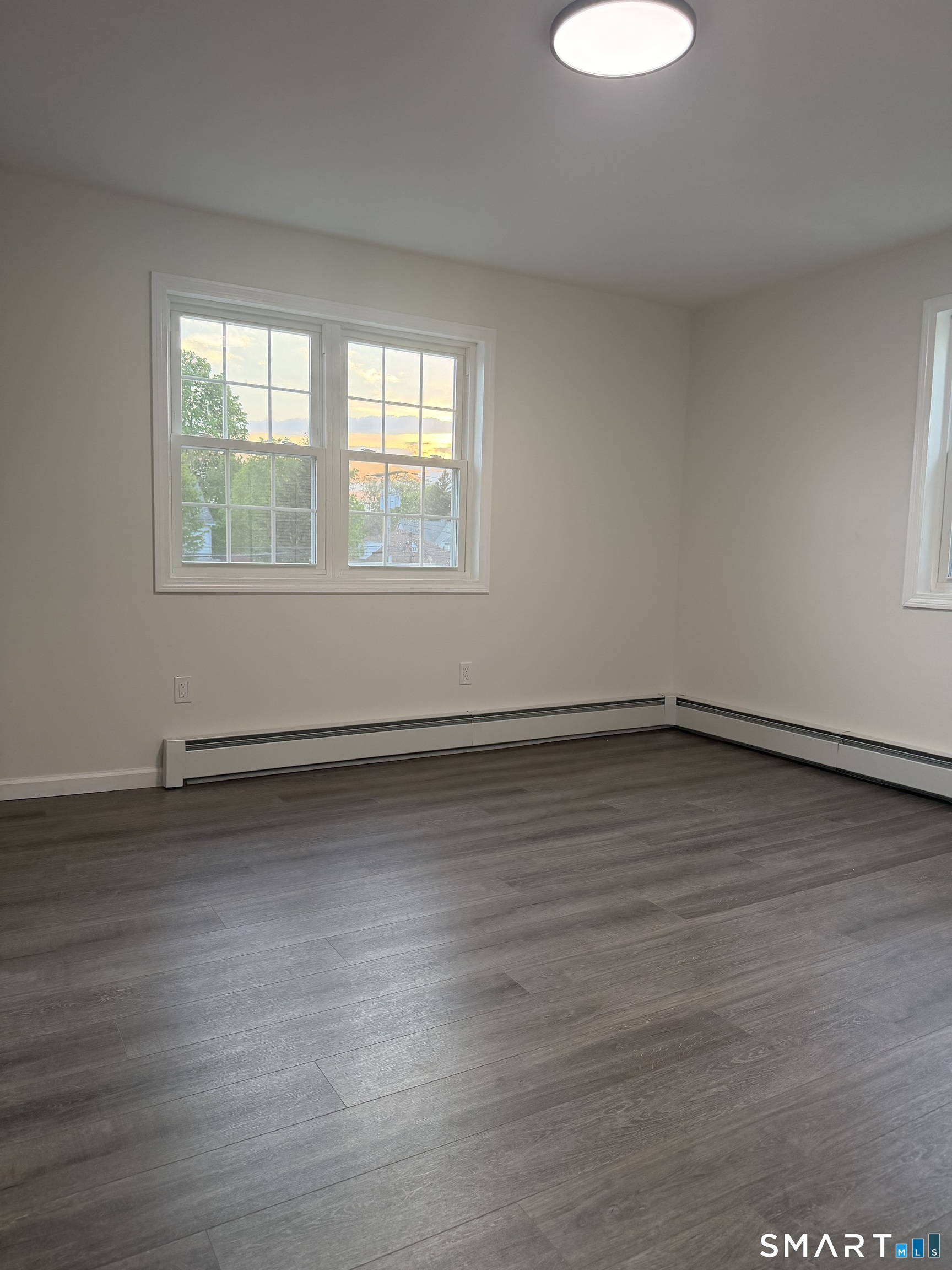 11 Strant Street Manchester, CT 06040 - Photo 7 of 8 an empty room with wooden floor and windows