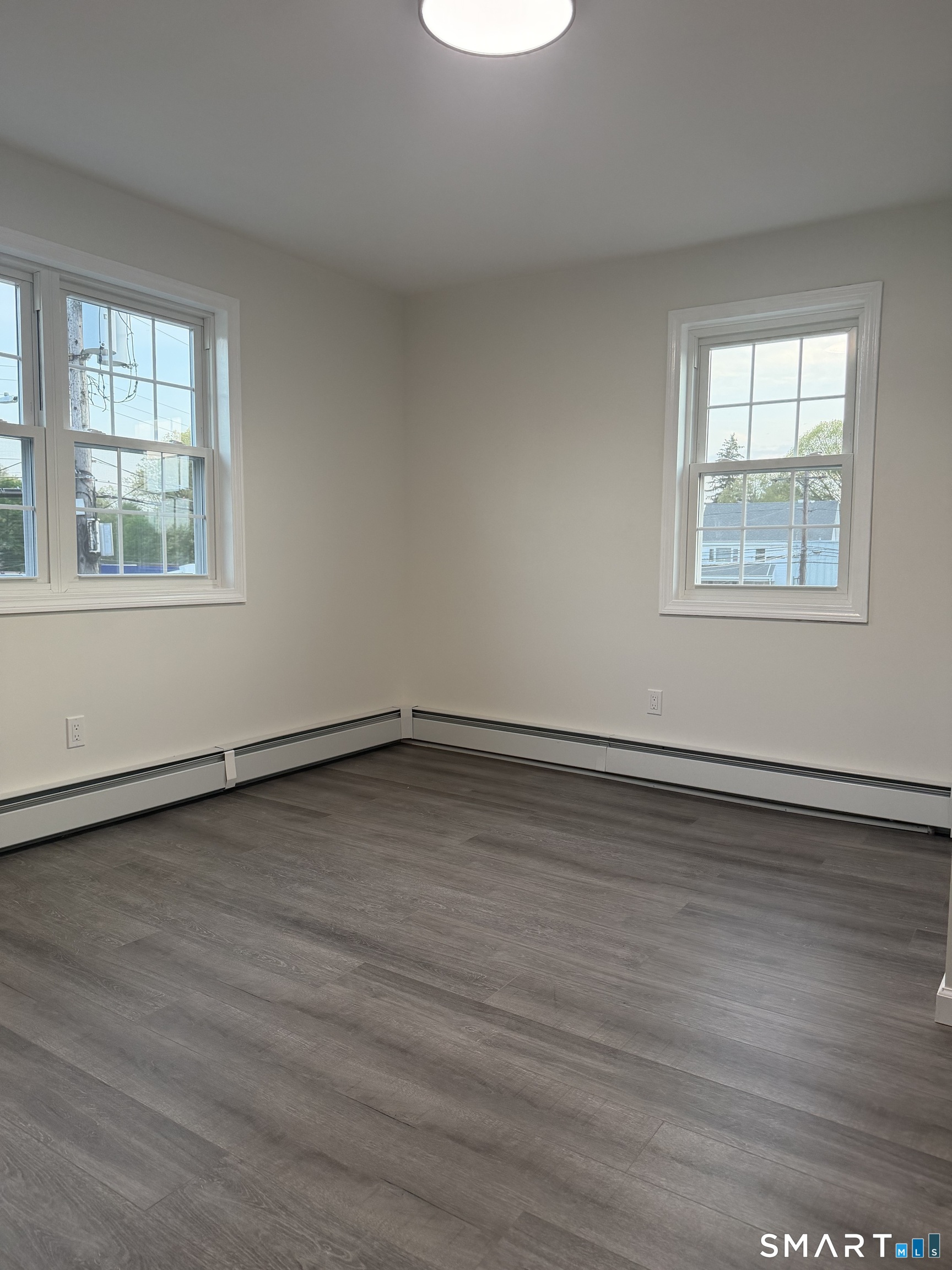 11 Strant Street Manchester, CT 06040 - Photo 8 of 8 an empty room with wooden floor and windows