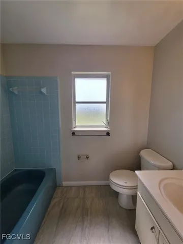 a bathroom with a toilet a sink and bathtub