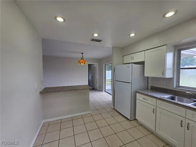 a kitchen with a refrigerator and a sink