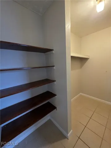 a view of walk in closet with empty racks