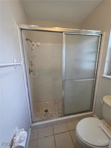a bathroom with a glass shower door