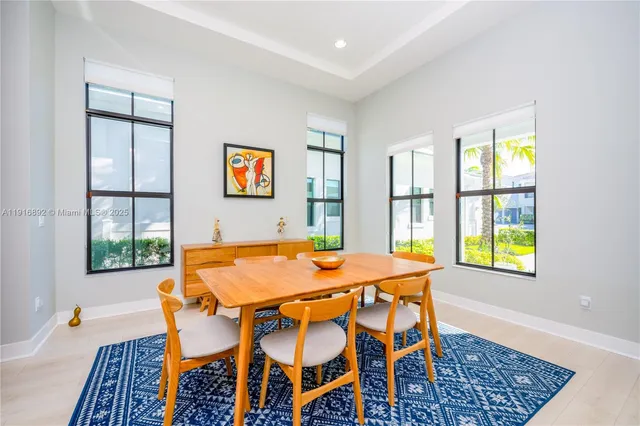 a view of a dining room with furniture and a window