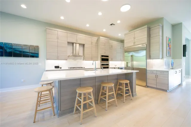 a living room with furniture a table and kitchen view