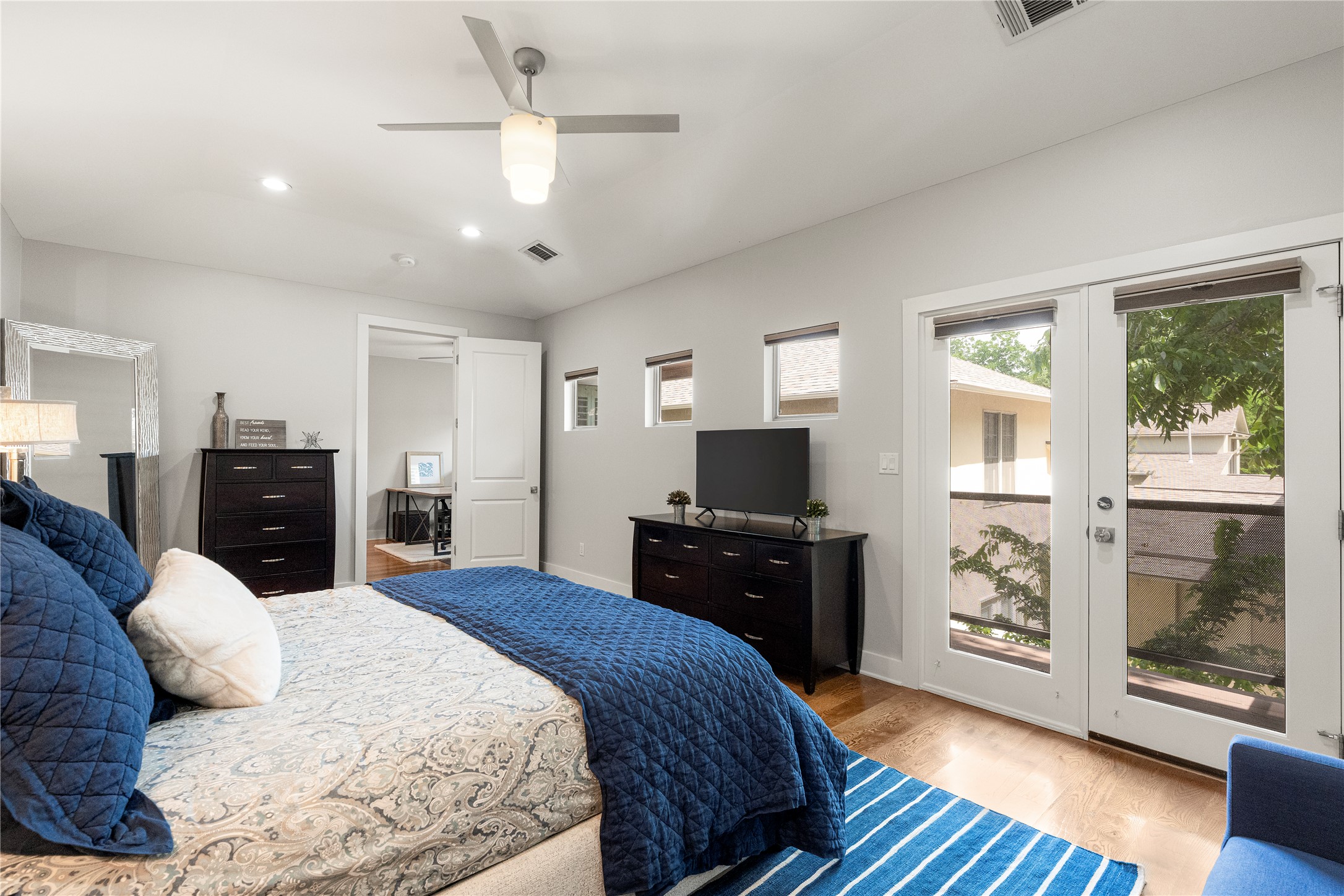 3814 Ridgelea Drive, Unit A Austin, TX 78731 - Photo 21 of 30 a bedroom with a bed and wooden floor