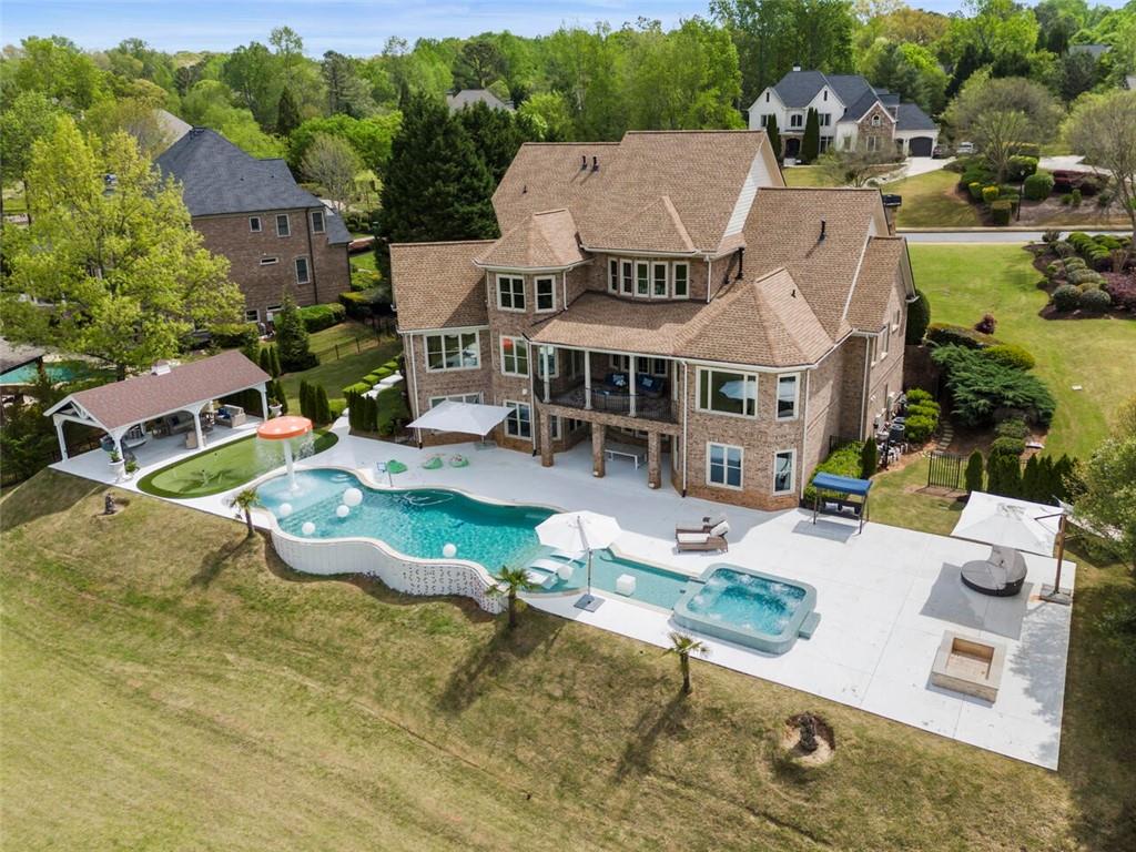 an aerial view of a house with swimming pool patio and outdoor seating