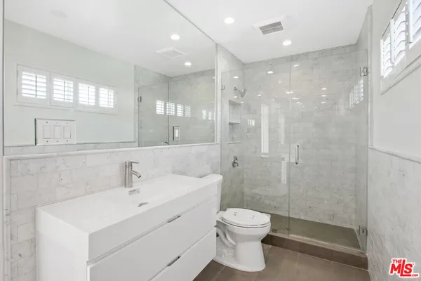 a bathroom with a toilet sink and shower