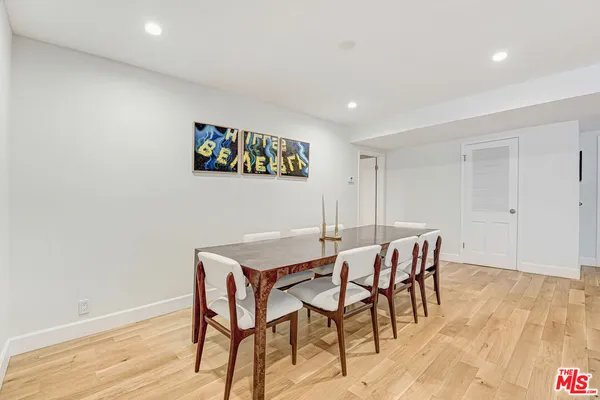 a view of a room with furniture and wooden floor