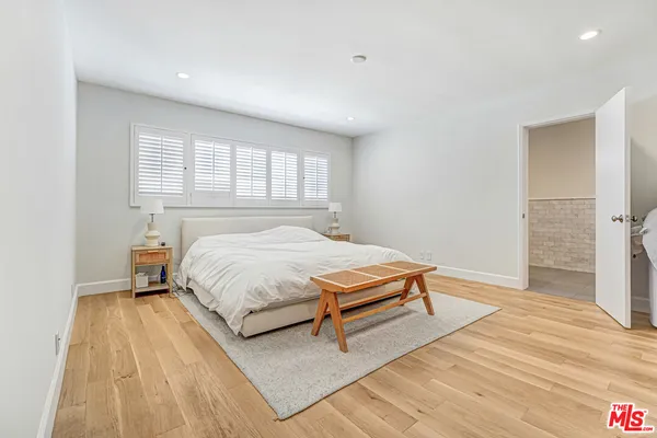 a bedroom with a bed and a table