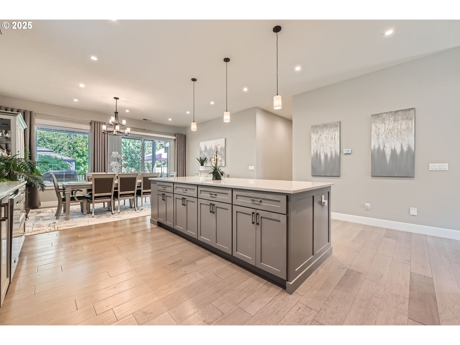 14880 Southeast Anderson Road Damascus, OR 97089 - Photo 12 of 45 a large white kitchen with a large island oven a sink dishwasher with couches and large couches with wooden floor