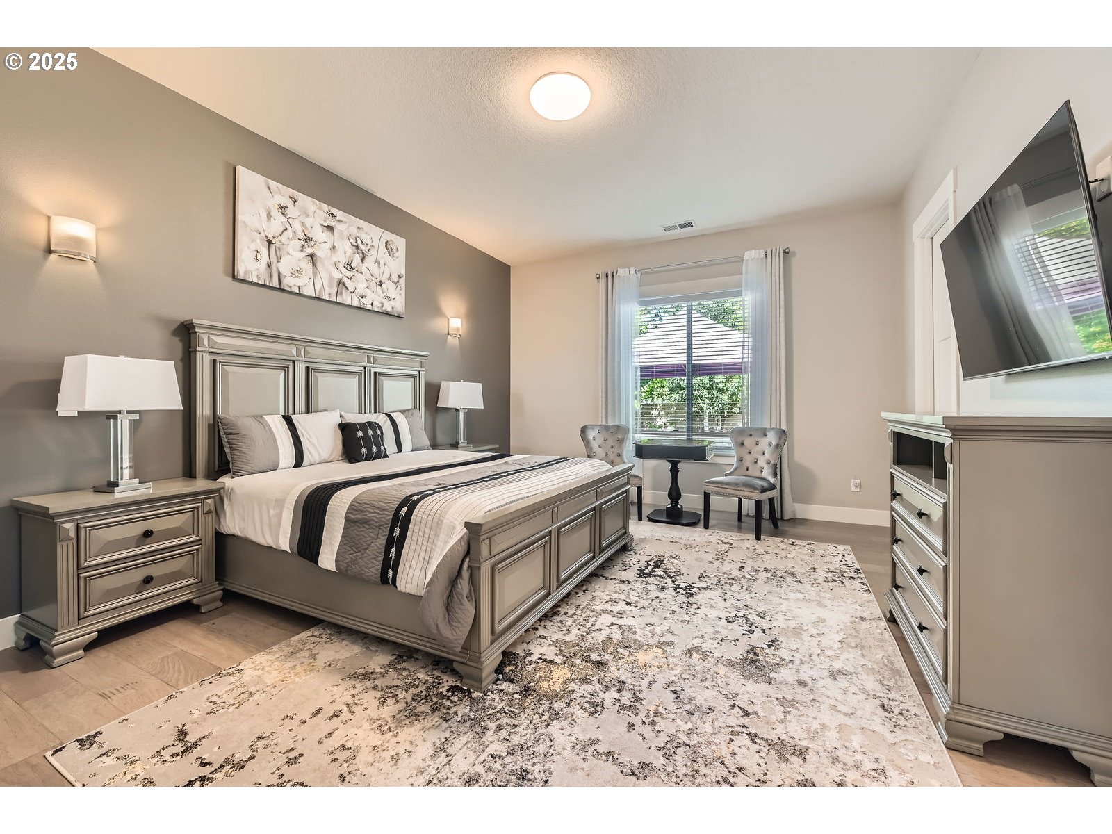 14880 Southeast Anderson Road Damascus, OR 97089 - Photo 20 of 45 a spacious bedroom with a bed and a flat screen tv