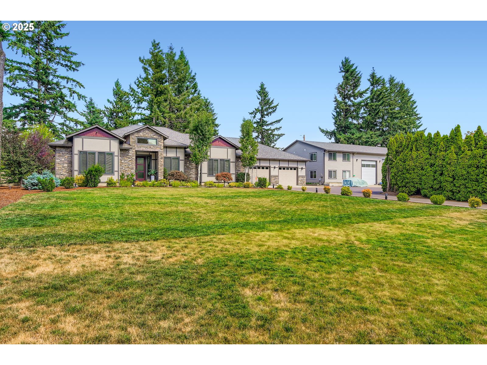 14880 Southeast Anderson Road Damascus, OR 97089 - Photo 2 of 45 a front view of a house with a garden