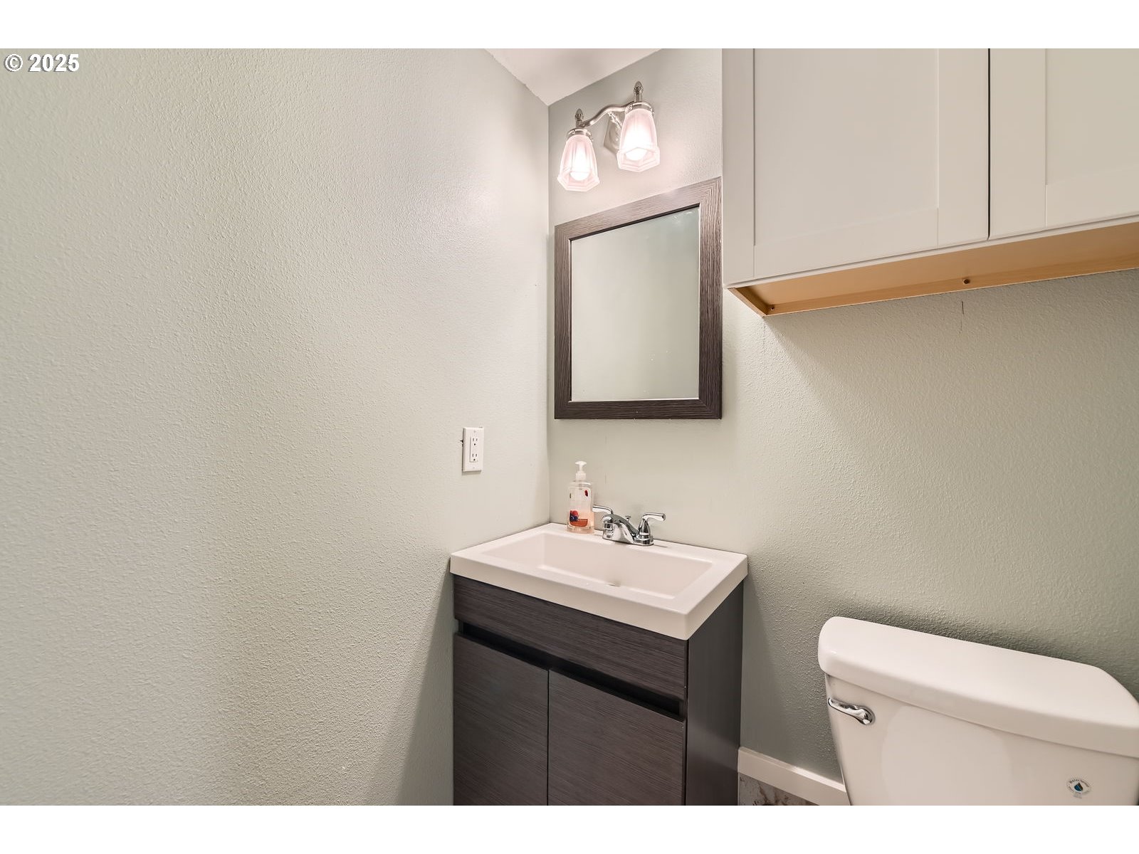14880 Southeast Anderson Road Damascus, OR 97089 - Photo 28 of 45 a bathroom with a toilet a sink and mirror