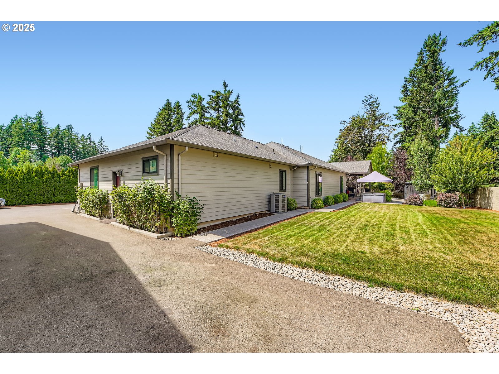 14880 Southeast Anderson Road Damascus, OR 97089 - Photo 39 of 45 a white house with a large yard plants and large trees