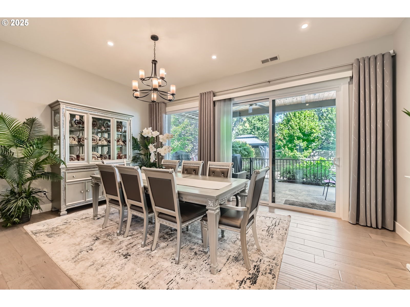 14880 Southeast Anderson Road Damascus, OR 97089 - Photo 9 of 45 a dining room with wooden floor a chandelier a wooden table and chairs