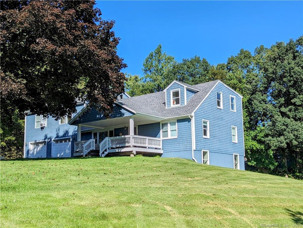 30 Knollcrest Drive Brookfield, CT 06804 - Photo 1 of 1 a front view of a house with a garden and trees