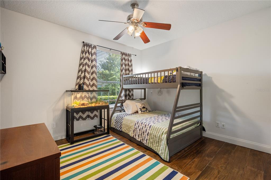2002 Water Key Drive Windermere, FL 34786 - Photo 24 of 60 a bedroom with a bed and a bookshelf