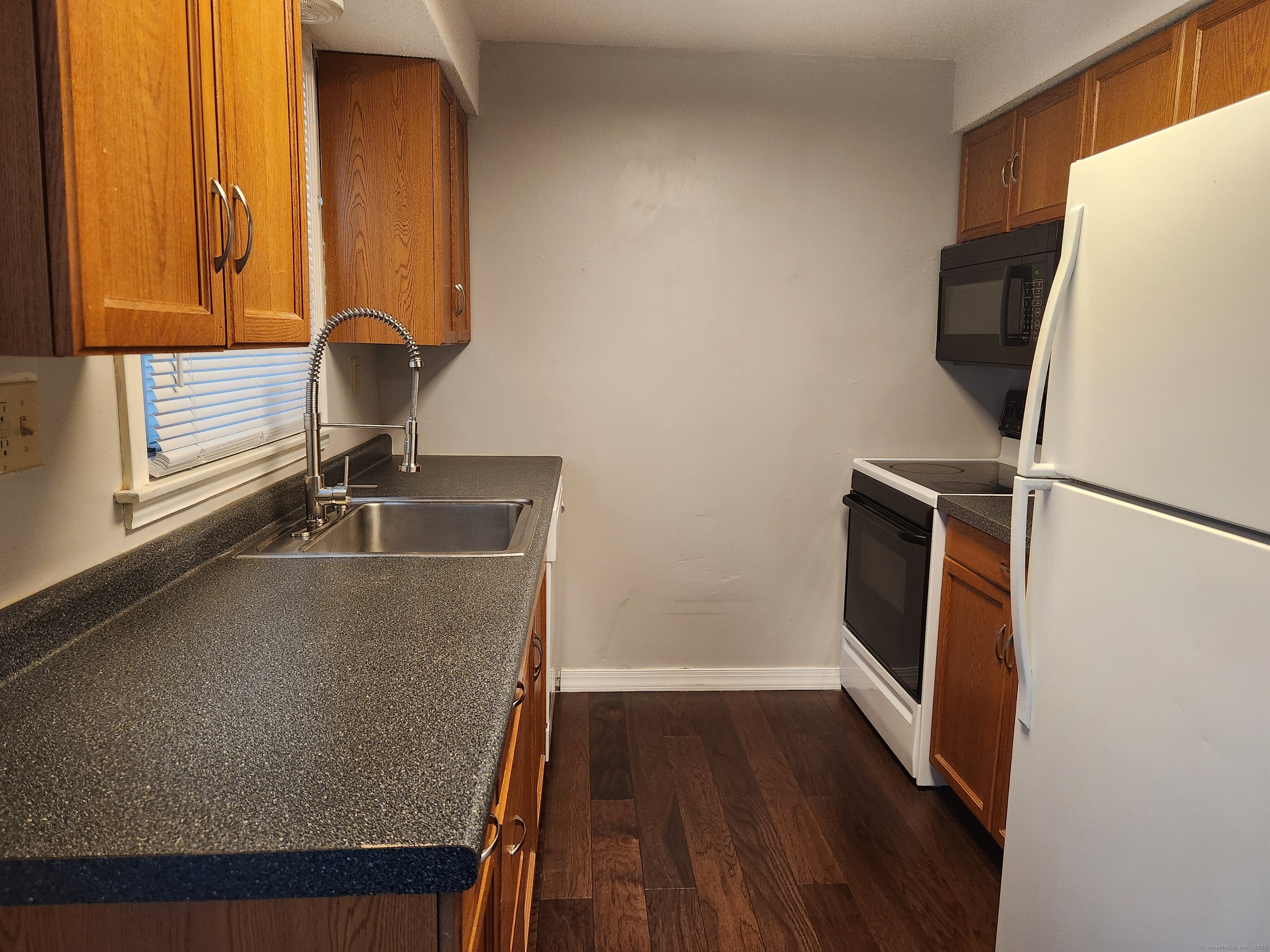 617 Center Street, Unit D Manchester, CT 06040 - Photo 12 of 18 a view of a storage and utility room with wooden floor