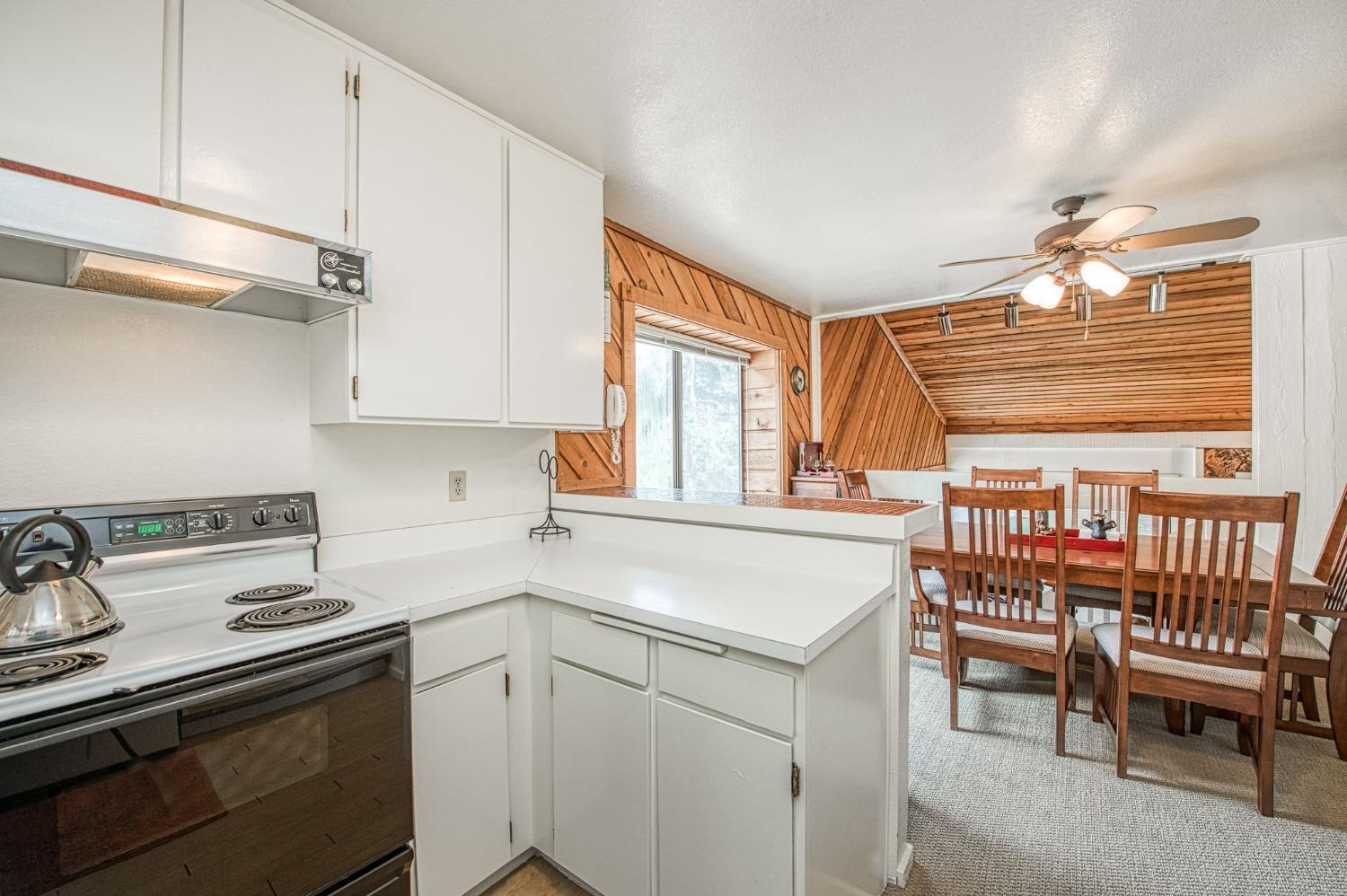 a kitchen with a stove a sink and cabinets