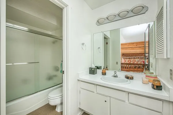 a bathroom with a double vanity sink toilet and shower