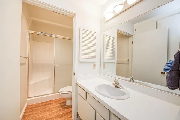 a bathroom with a sink toilet and shower