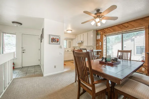 a view of a dining room with furniture and window